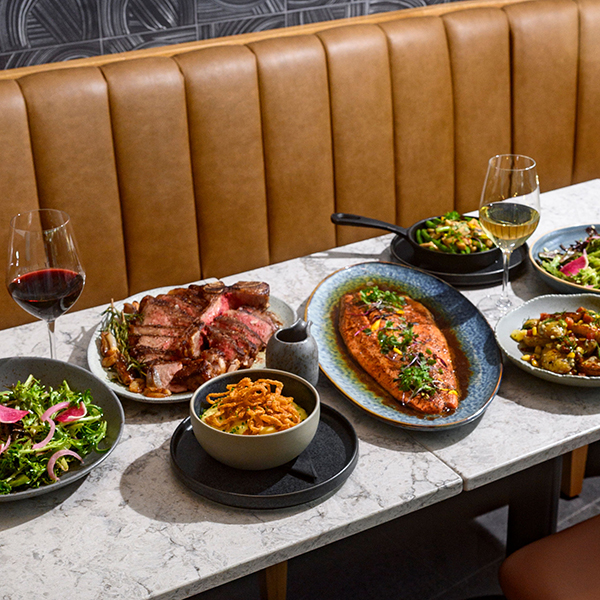 A leather banquette set with dinnerware at Wildlight Restaurant